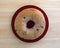 Blueberry bagel on red dish top view