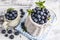 Blueberry basket and jug on white wooden table