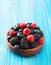 Blueberry, blackberry, raspberry, bowl on wooden background - vintage effect style pictures