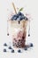 Blueberry boba milk tea or bubble tea in a tall glass with a straw, watercolor style