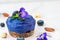 Blueberry and butterfly pea flower vegan cashew cheesecake with fresh berries, edible flowers