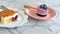 Blueberry cheese pie cake and whipped cream on pink plate with golden spoon, eat with carrot cheese cake good for eating.