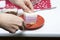 Blueberry cheesecake. A woman puts a piece of ready-made dessert on a saucer. Jelly layers of different colors are visible