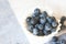 Blueberry closeup. Freshly picked blueberries in wooden bowl over rustic background.