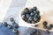 Blueberry closeup. Freshly picked blueberries in wooden bowl over rustic background.