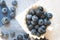 Blueberry closeup. Freshly picked blueberries in wooden bowl over rustic background.