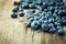 Blueberry, great bilberry or bog whortleberry on wooden board