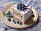 Blueberry lemon cake on white plate with blueberry slice, in the style of multilayered realism.Generative AI