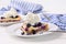Blueberry lemon tart with whip cream on wood table