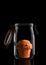 A Blueberry Muffin in a glass storage or canning jar isolated on black with reflection, with lid open