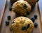 Blueberry muffins with fresh fruit on wooden tray