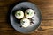 Blueberry muffins with lemon and mint on gray plate on dark wooden table. Top views with clear space