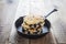 Blueberry  pancakes in cast iron skillet, fresh summer dessert