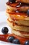 Blueberry pancakes drenched with maple syrup. macro