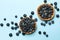 Blueberry pies on blue background, top view