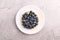 Blueberry tart on the table. tart with blueberry in plate and light background. top view