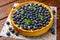 Blueberry Tart on vintage wooden background