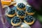 Blueberry tartlets on slate stone.