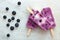 Blueberry vanilla ice pops on white marble