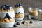 Blueberry yogurt parfait with granola and chia seeds in glasses