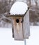 A Bluebird House With Snow On The Roof