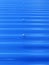 Blueish metallic corrugated sheet roof texture. Deep blue profiled sheet panel. Corrugated Metal Roof Exterior Close up