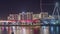 Bluewaters Island in Dubai aerial night time lapse with illuminated buildings.