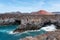 Bluff coast and vulcanic landscape at Los Hervideros, Lanzarote, against sky