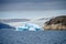 Bluish iceberg in to the front of a glacier