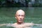 Blunt Japanese bald head guy soaked in the river