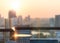 Blur abstract background city morning gold light sky rooftop view over cityscape with bright sun flare and bokeh