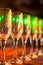 Blur abstract background interior of dark brown bar. Empty glasses for wine above a bar rack. Classic bar counter with