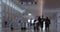 Blur of airport hall with people and travelator