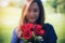 Blur Asian women giving red roses flower to her boyfriend on Valentine`s day