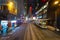 Blur background of tram or bus view at night. Crowd of people on street of Central district. Transportation for tourists visiting