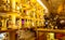 Blur a bottle of alcoholic drink on the shelves in club pub or bar against backdrop of dark party. Brightly lit bottles of