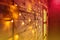 Blur Christmas lights on wooden planks and door. Bright glowing garland. New Year lights background. Yellow red color