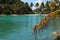 Blur coconut palm leaves on ropical island beach background. Sand spit in the sea.