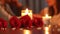 blur of Couple at a candle light dinner date holding hands with focus on bouquet of red roses on table. Generative Ai