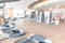 Blur gym background fitness center or health club with blurry sports exercise equipment for aerobic workout and bodybuilding