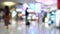 Blur of passenger moving in duty free shop