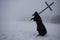 Blur picture of Medieval plague doctor with bird mask to carry a cross on winter field