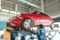 blur red car wheel alignment in progress at auto repair service centre background
