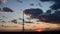 Blur silhouette of communication tower with sunset cloudscape skyline