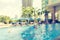 Blur swimming pool background of resort hotel poolside summer party relaxation with blue cool sky