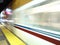 Blur of VTA transit lightrail train arrives into station at night