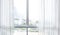 Blur of white curtain on window with city view background