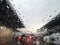 Blured background with rains drop on glass and cars on the road, Road view through car window blurry with rain and traffic jam in