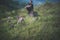 Blured of traveller male with backpack sitting on rock at nature,Meditations to calm your mind and body