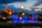 Blurred abstract background lights, beautiful fountain front of royal Thai temple.